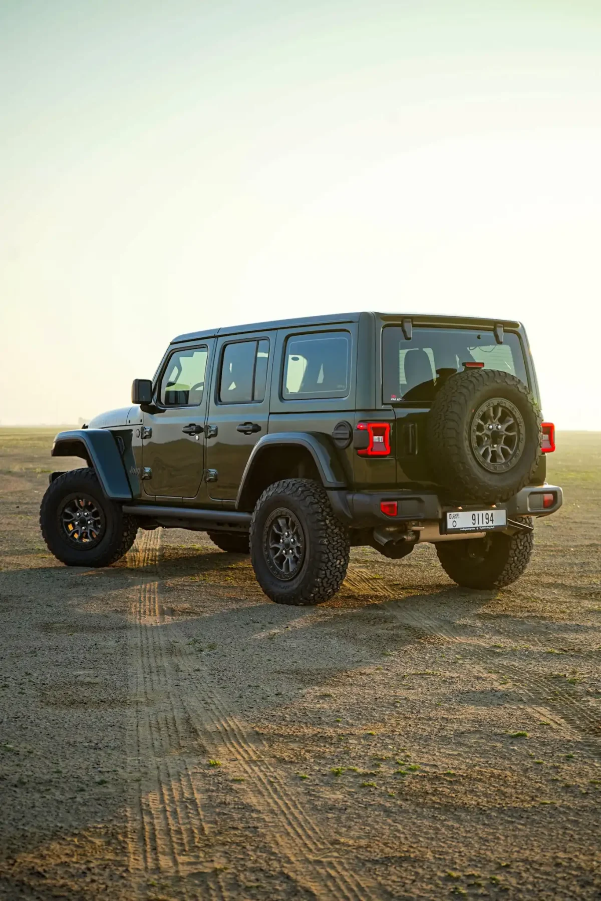 a picture of Jeep Wrangler available for rental in dubai with tailside side view