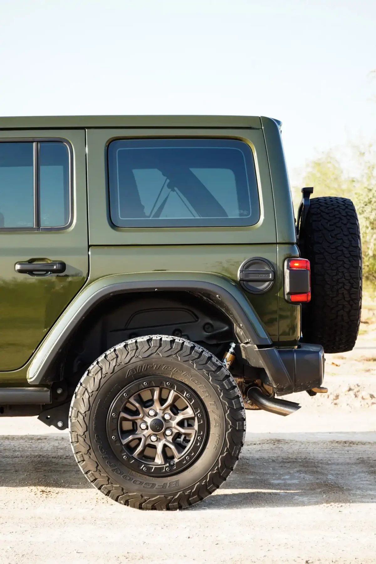 a picture of Jeep Wrangler available for rental in dubai with back side tyre view