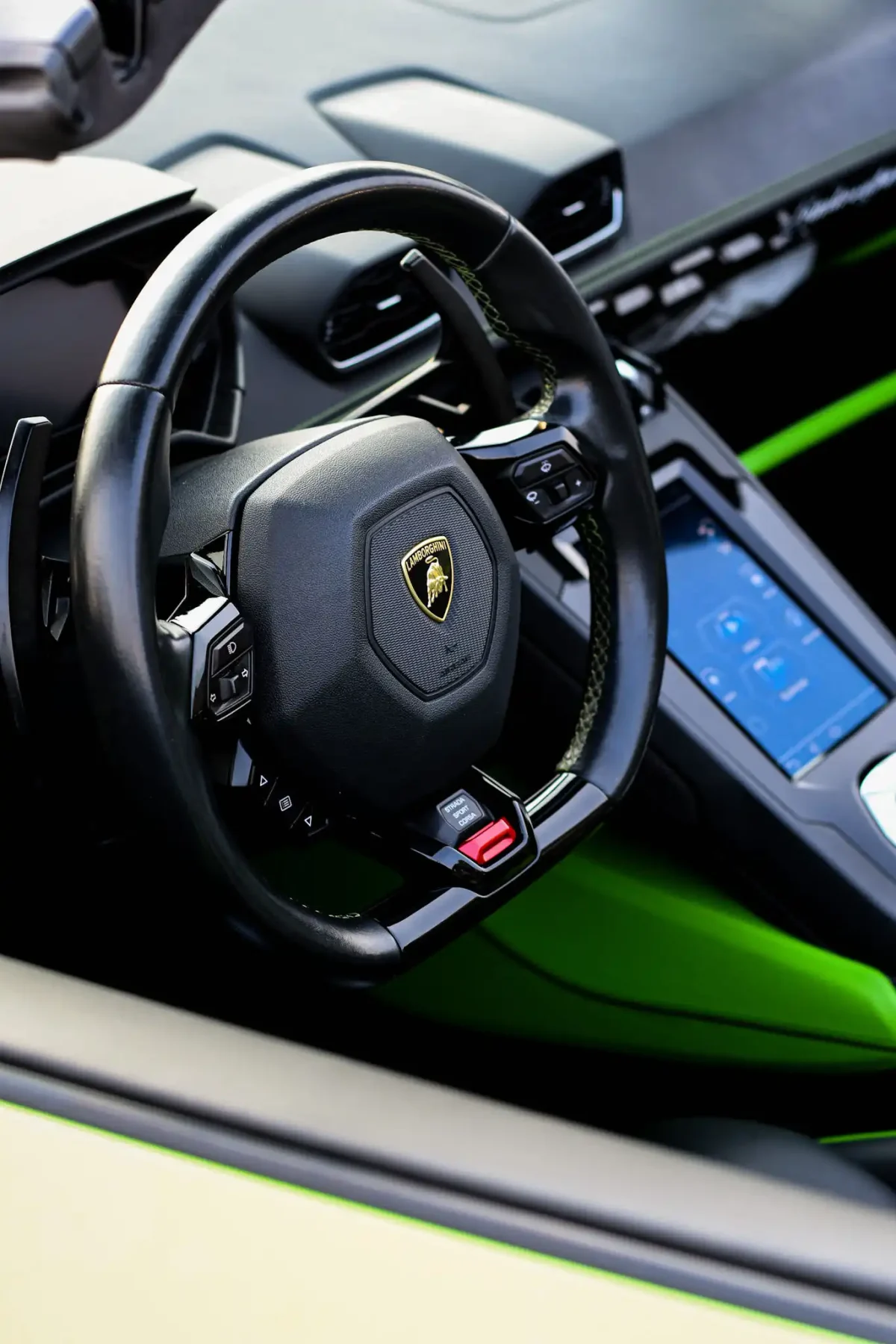 a picture of LAMBORGHINI HURACAN EVO SPYDER available for rental in dubai with steering wheel view