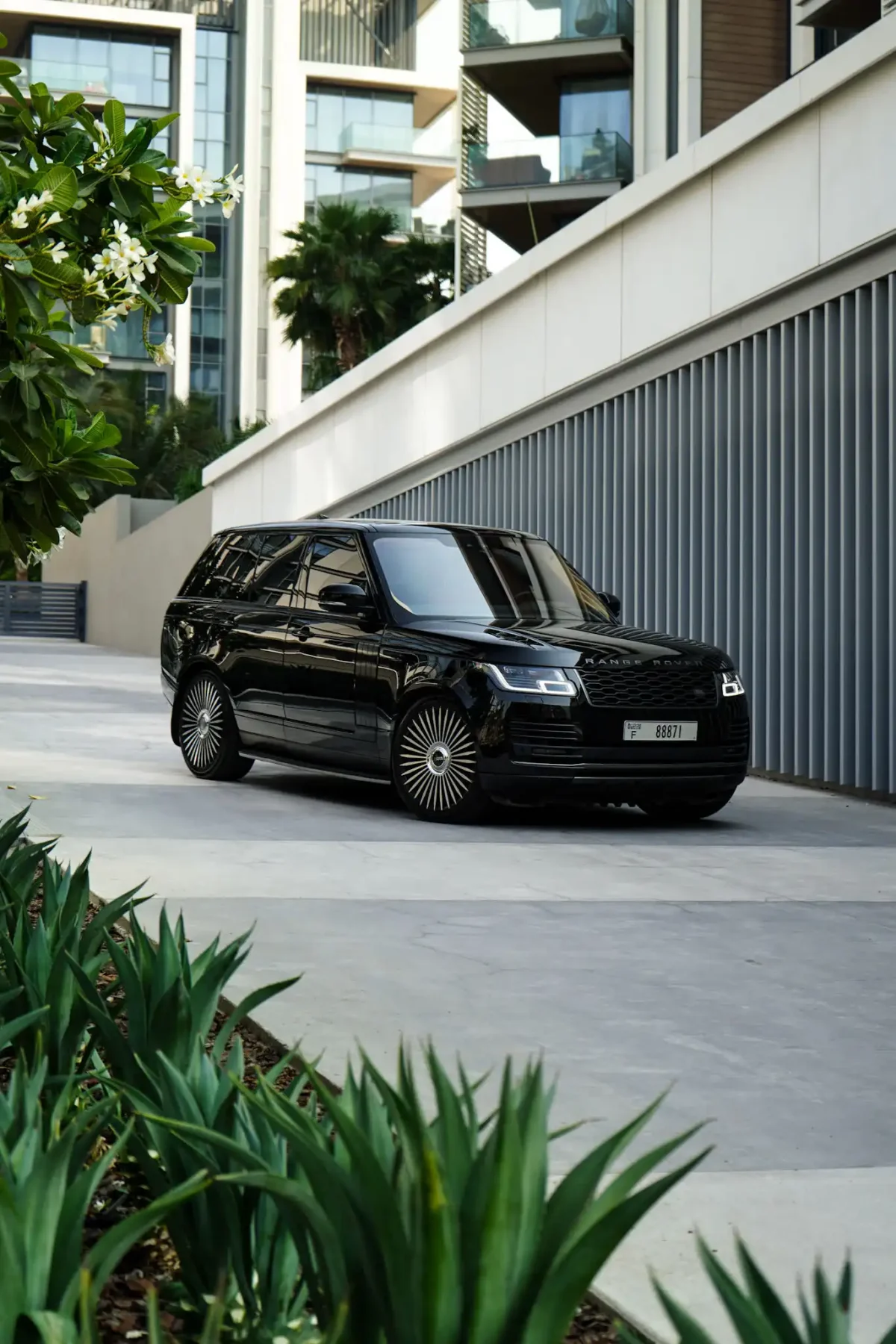 a picture of RANGE ROVER VOGUE available for rental in dubai with side view parked outside