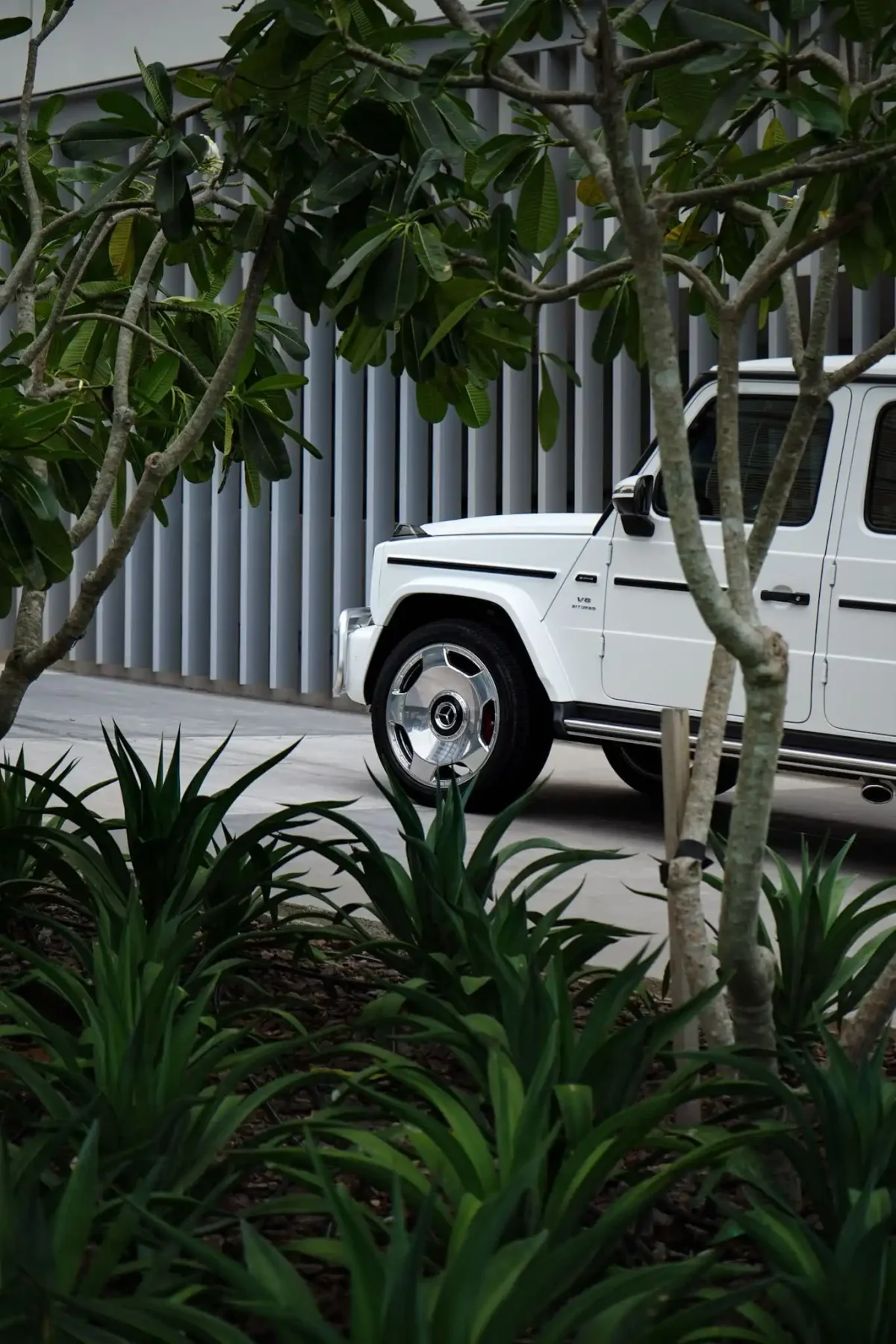 a picture of Mercedes G63 Matte White parked outside available for rental with sideview