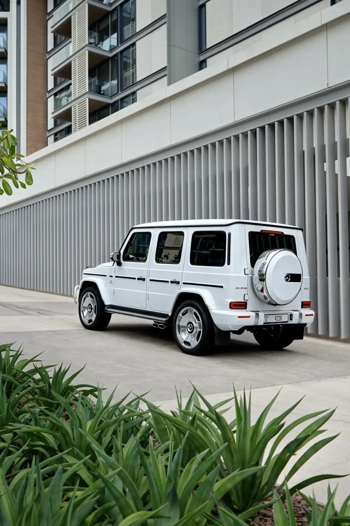 a picture of Mercedes G63 Matte White parked outside available for rental with back view