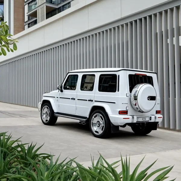 a picture of Mercedes G63 Matte White parked outside available for rental with back view