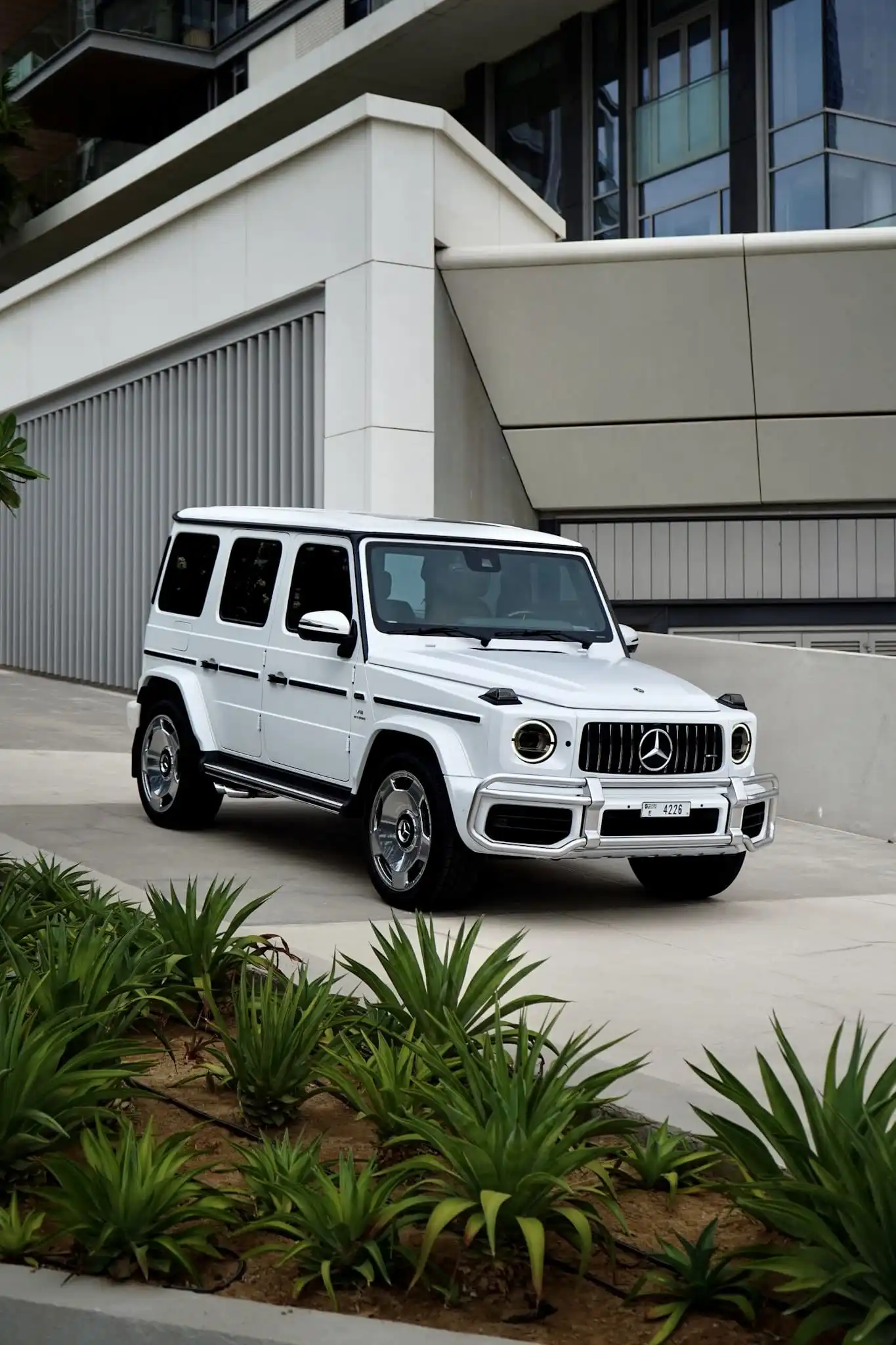 a picture of Mercedes G63 Matte White parked outside available for rental