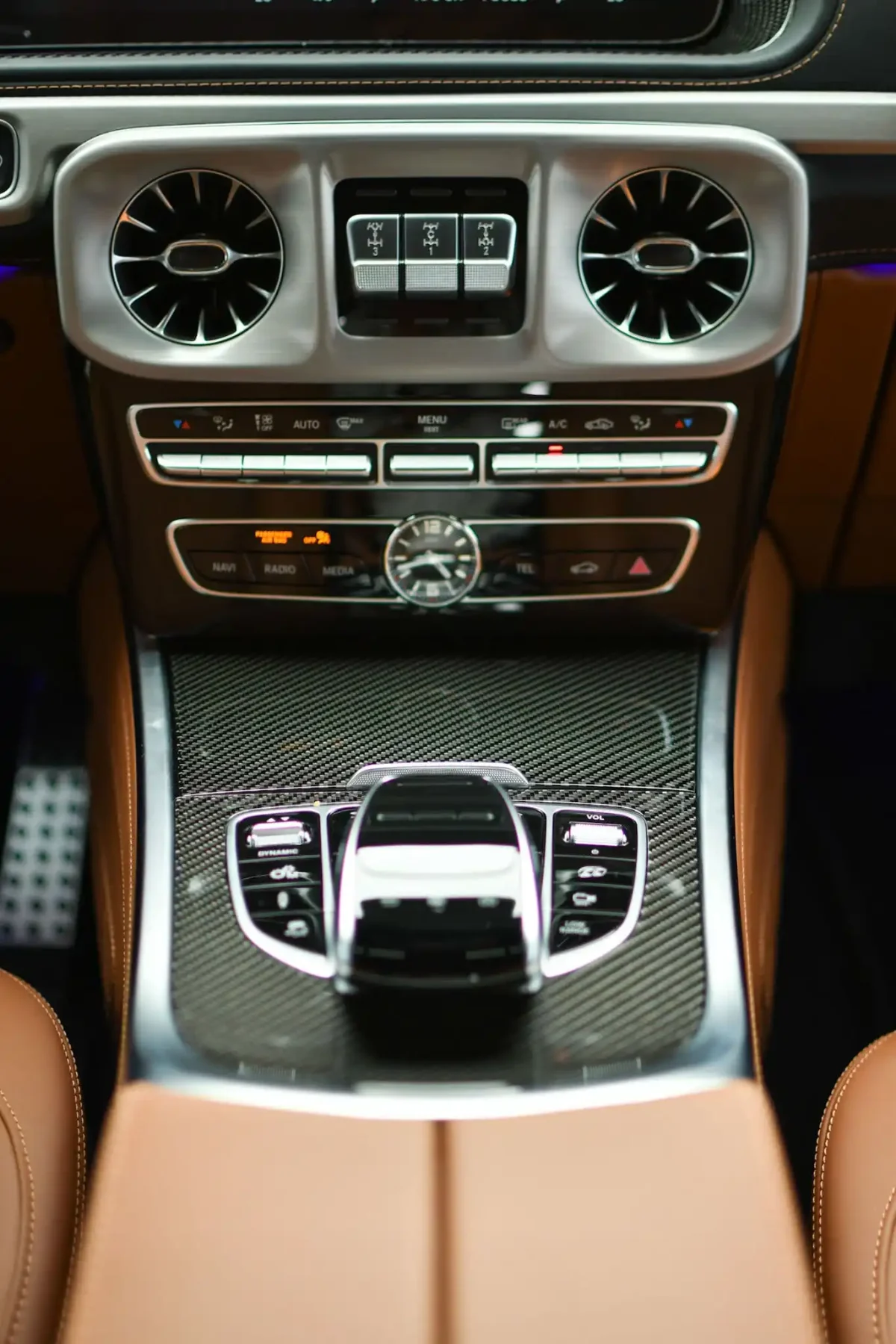 a picture of Mercedes G63 Matte White parked outside available for rental with central console view